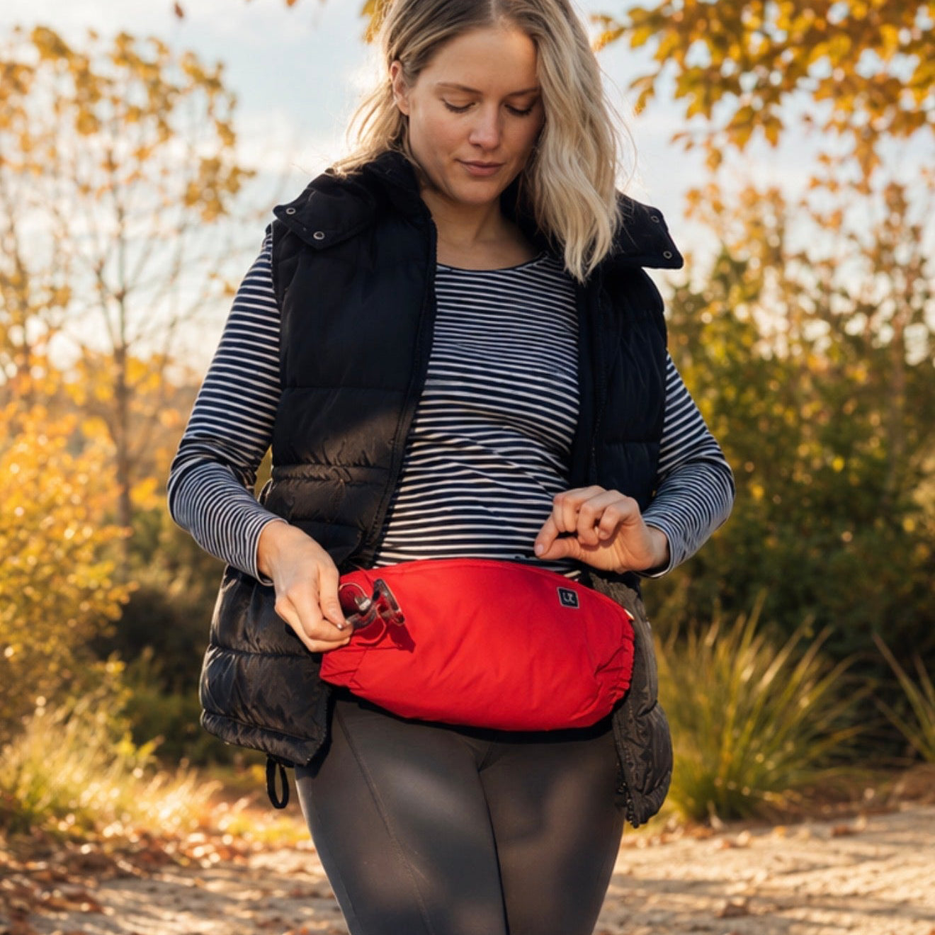 Woman in outdoor setting with heated hand warmer